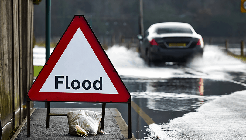 car driving through a flood uk road